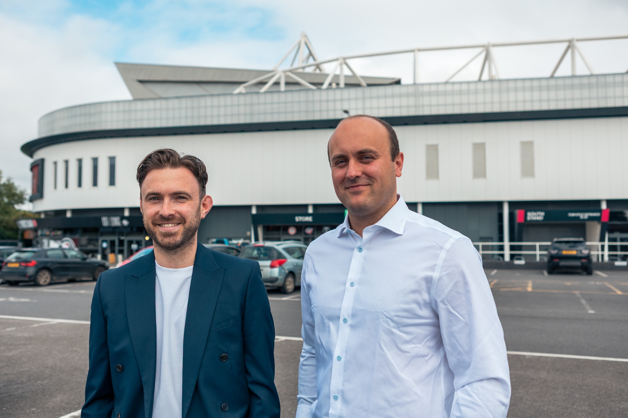 The Digital Cogs founders Olly and Owen outside a stadium